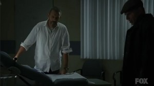 House looks on as his patients faints just as he predicted.