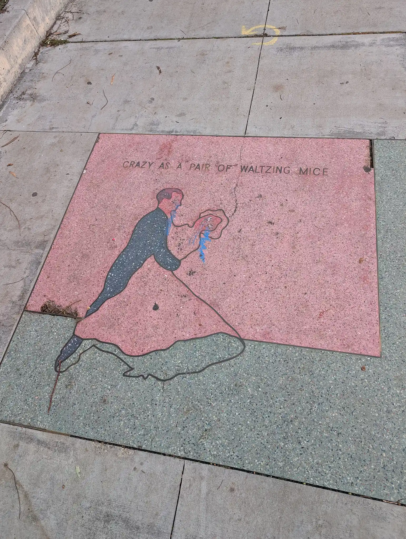 A terrazzo medallion by Alexis Smith featuring a Raymond Chandler line from Farewell, My Lovely (and other works &ndash; seems to be his favorite way to say something&rsquo;s weird/strange/nonsense).